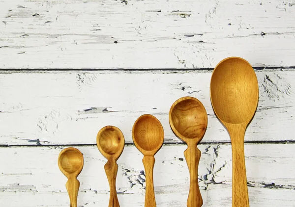 Wooden kitchen spoon on the table, top view — Stock Photo, Image