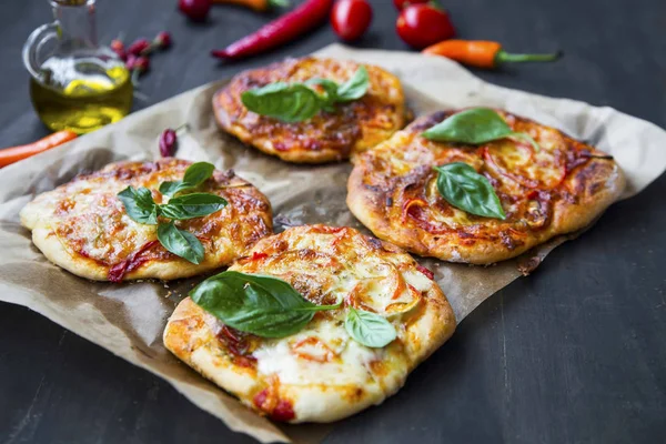 Mini pizzas with cheese, salami and spices freshly baked — Stock Photo, Image