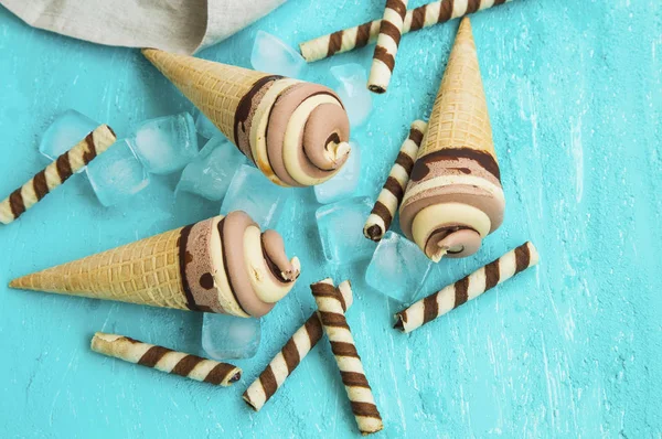 Chocolate and caramel ice cream creamy spirals in waffle cones