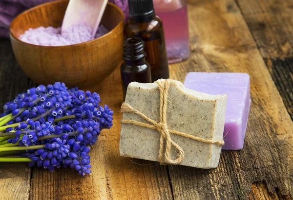 Spa setting still life with natural soap, purple flowers, oil bo — Stock Photo, Image