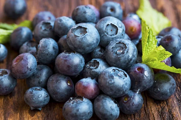 Nahaufnahme von Blaubeeren-Haufen auf Holzgrund — Stockfoto