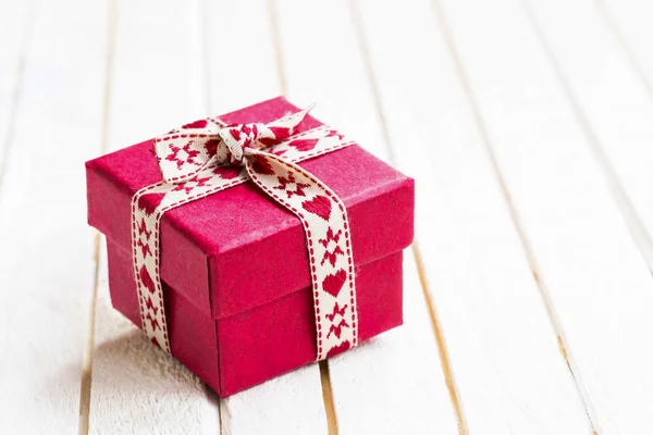 Festive Christmas gift with ribbon — Stock Photo, Image