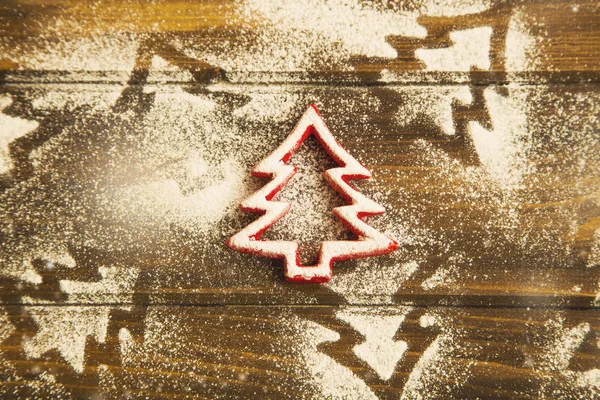 Christmas tree ornament with icing sugar on wooden background,to — Stock Photo, Image