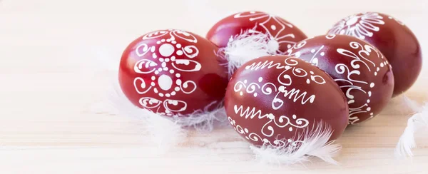 Easter eggs with feathers — Stock Photo, Image