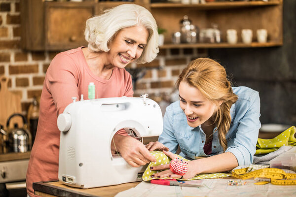 Women using sewing machine 