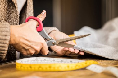 Woman cutting fabric  clipart