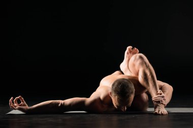 Adam yoga pozisyonunda oturuyor.