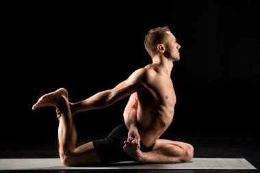 Adam yoga pozisyonunda oturuyor.