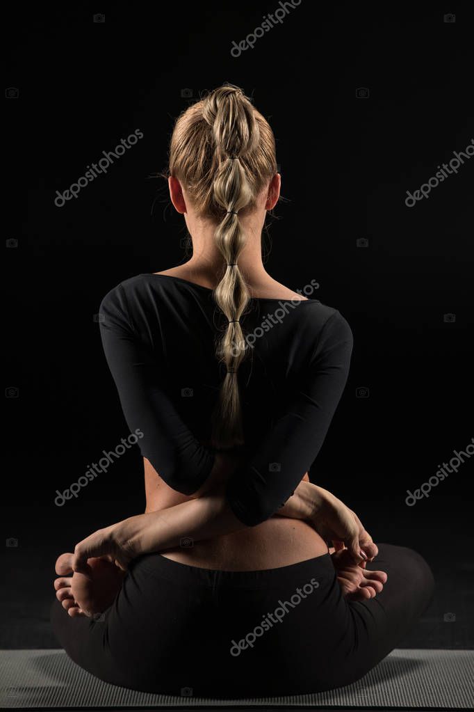Rear View Of Woman Performing Baddha Padmasana Or Locked Lotus Pose Isolated On Black 135646120 Larastock