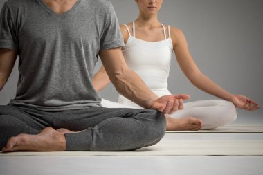 Couple sitting in lotus position  