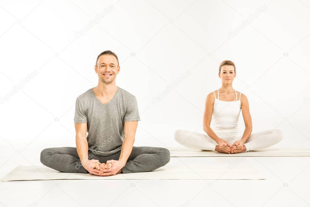 Couple sitting in lotus position 