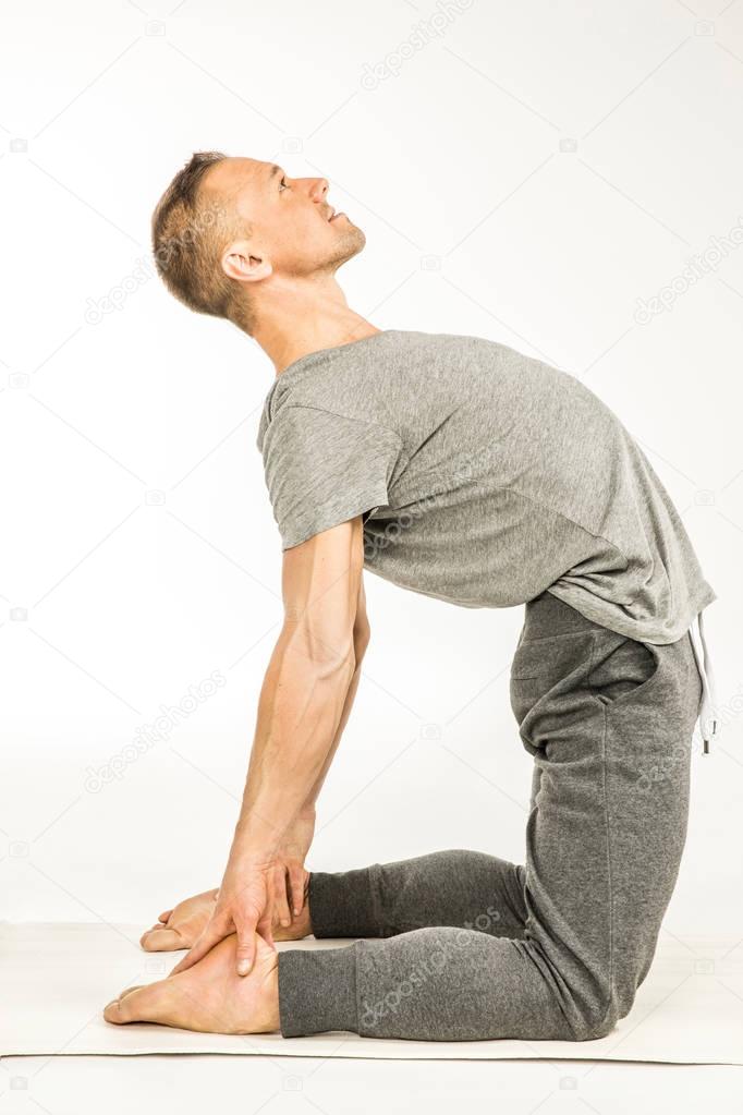 Man standing in yoga pose  