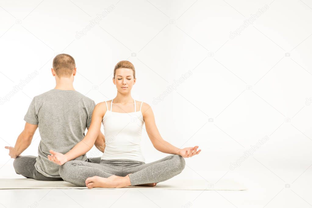 Couple sitting in lotus position  