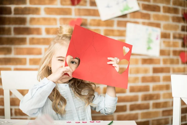 Meisje bedrijf rood papier — Stockfoto