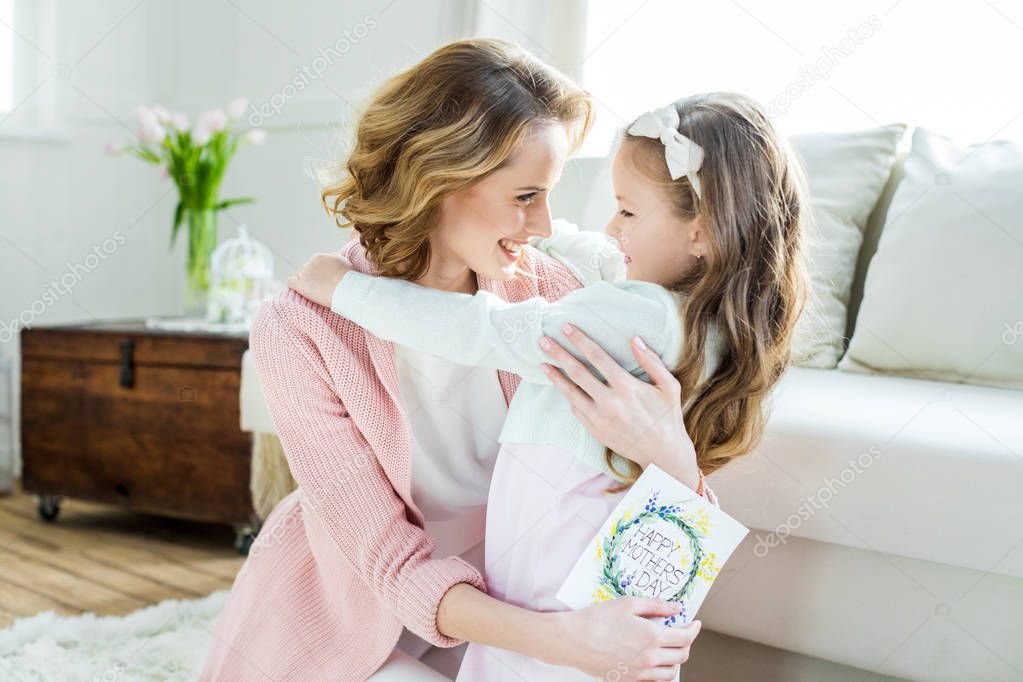 Happy mother and daughter hugging