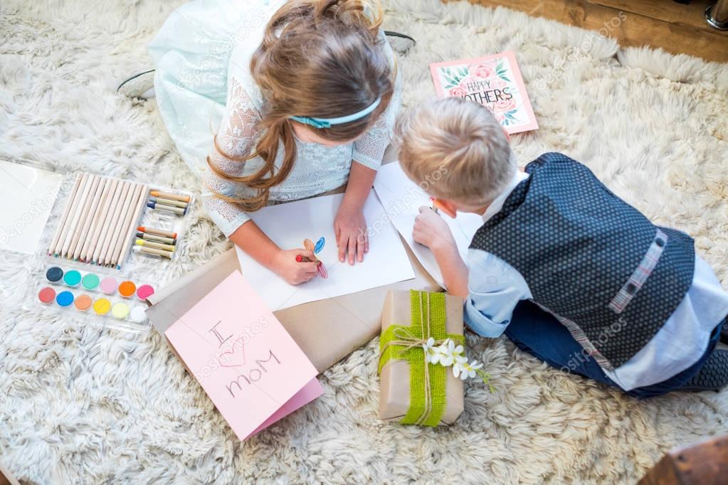 Siblings preparing present 