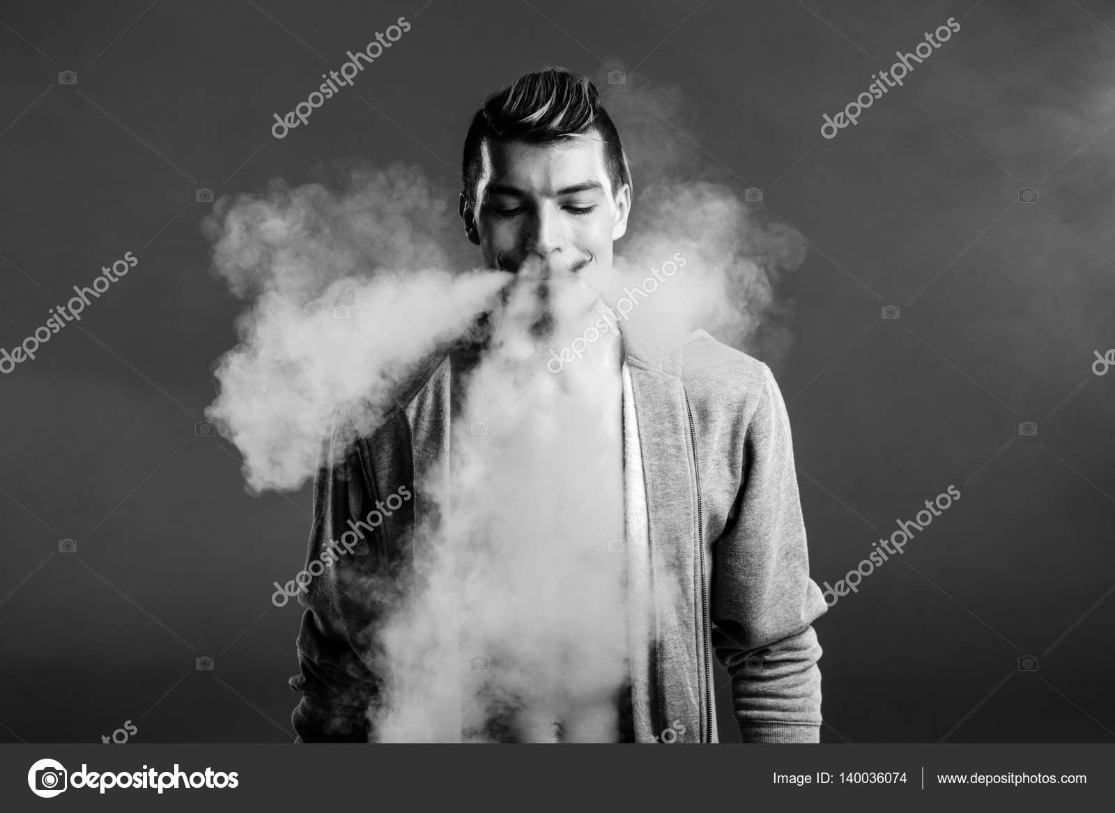 Young man vaping — Stock Photo © OlgaZakrevskaya 140036074
