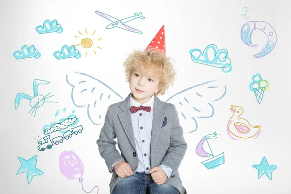 Curly boy in cone hat — Stock Photo, Image