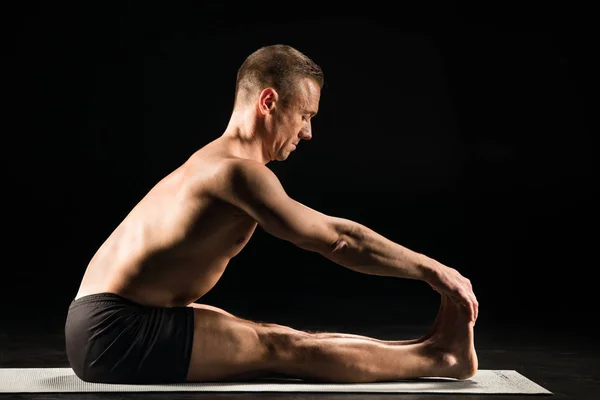 Man sitting in yoga position — Stock Photo