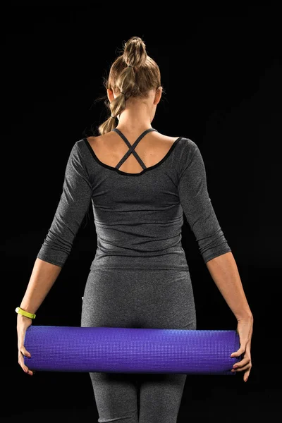 Sportswoman in possesso di tappetino yoga — Foto stock