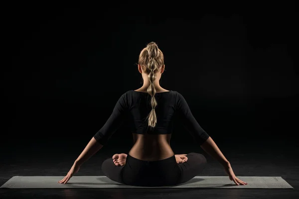 Woman sitting in lotus position — Stock Photo