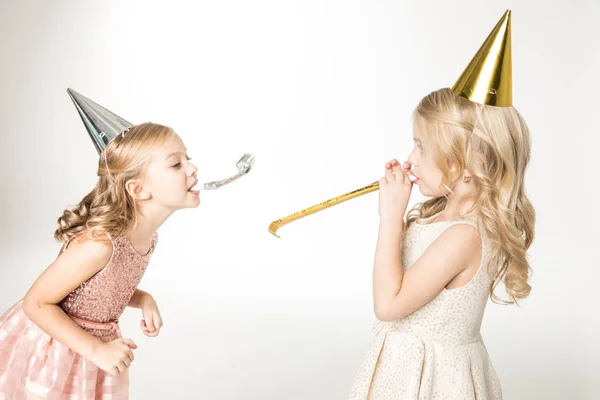 Kids with party blowers — Stock Photo