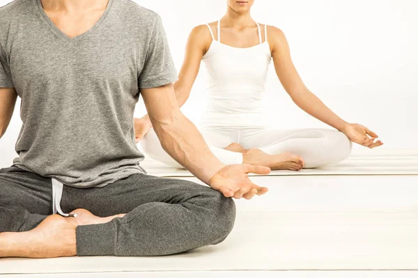 Couple sitting in lotus position — Stock Photo
