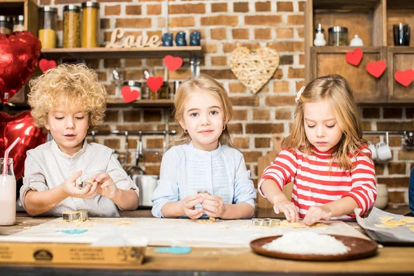 Children cooking biscuits — Stock Photo