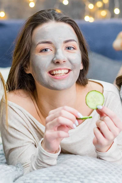 Young woman with facial mask — Stock Photo