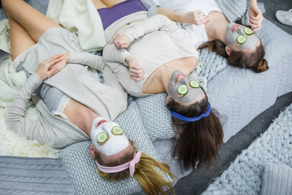 Young women with facial masks — Stock Photo