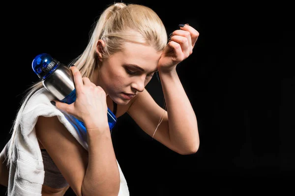 Sportswoman holding bottle — Stock Photo