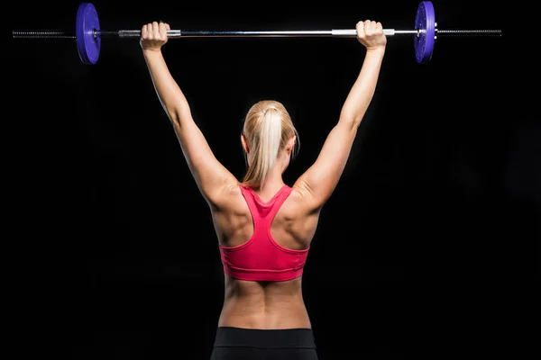 Woman exercising with barbell — Stock Photo