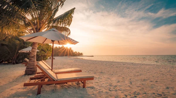 Beautiful beach background for summer travel with sun,coconut tree and beach wooden bed on sand with beautiful blue sea and blue sky. Summer mood sun beach background concept. Stock Picture