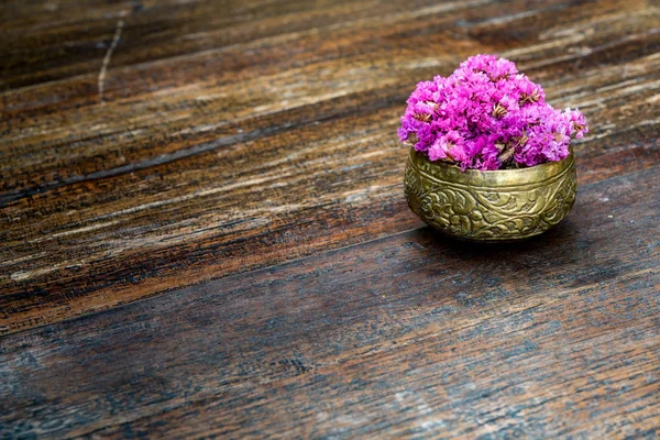 Pink flowers in brass bowl — Stock Photo, Image