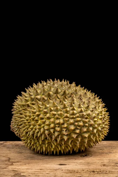 Durian en escritorio de madera — Foto de Stock