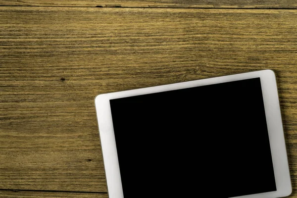 Black screen tablet on wood — Stock Photo, Image