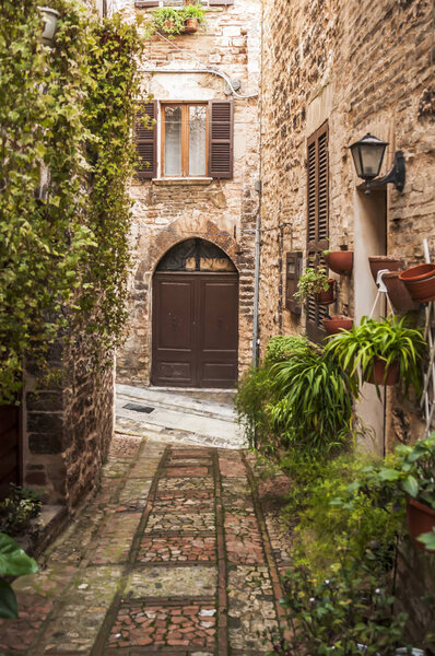 Narrow street in the small town of Spello, Umbria region, Italy