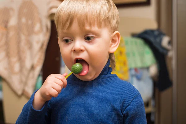 Blonde boy licking a Lollipop — Stock Photo, Image