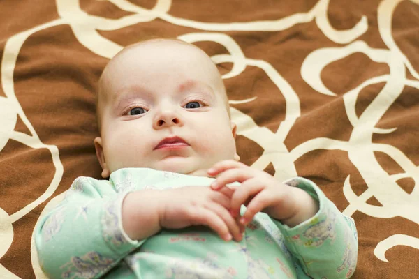 Pensive kid lying on the bed — Stock Photo, Image