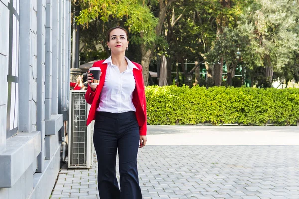 Jovem mulher de negócios com café na mão ao ar livre — Fotografia de Stock