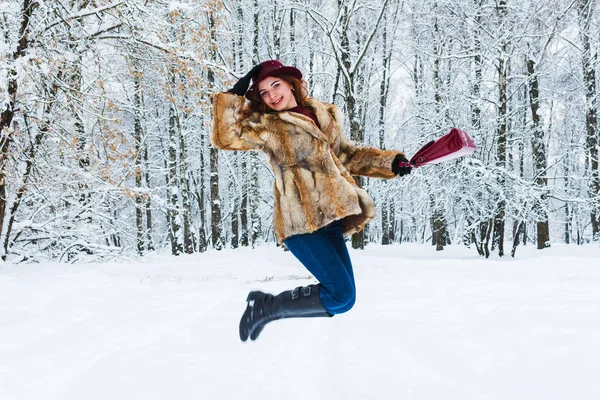 Jovem alegre pulando na floresta de inverno — Fotografia de Stock