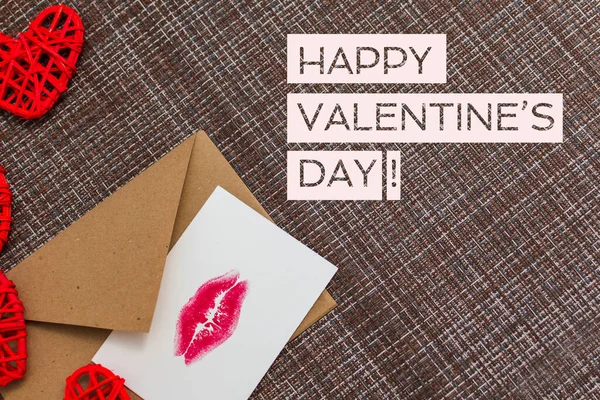 Kraft envelope, hearts and card with a lip print. the concept of — Stock Photo, Image