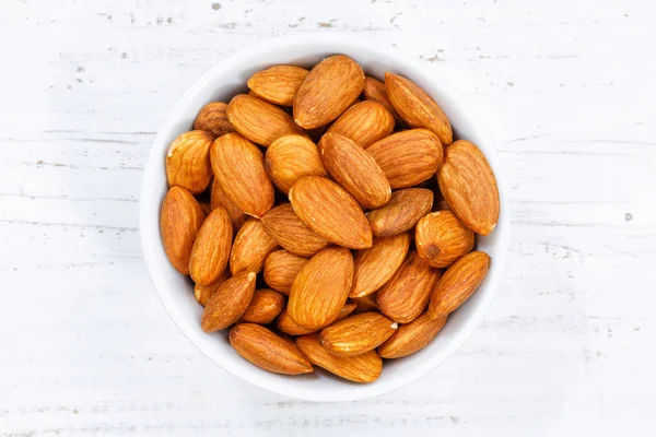 Almonds almond from above bowl wooden board — Stock Photo, Image