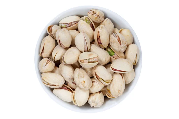 Pistachios pistachio nuts from above bowl isolated on white — Stock Photo, Image