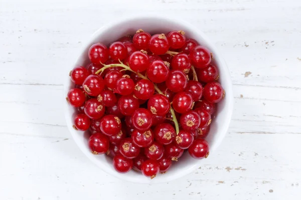 Red currants berries from above bowl wooden board — Stock Photo, Image