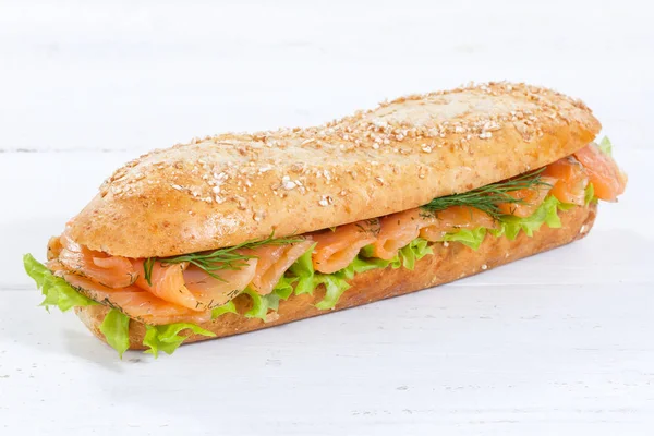 Sandwich whole grains baguette with smoked salmon fish on wooden — Stock Photo, Image