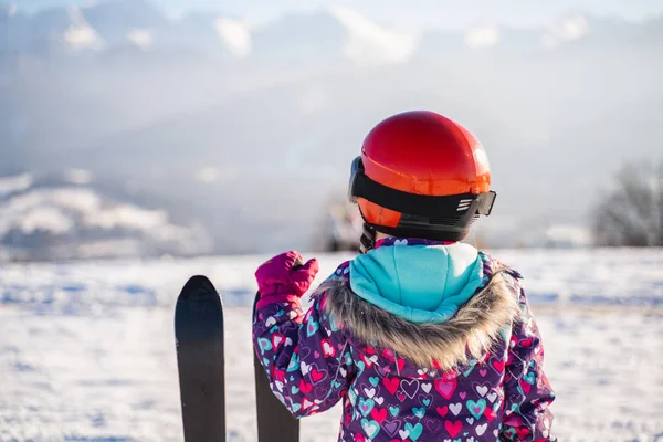 Back view of children standing on rural roadway in snow looking at mountain range in sunshine — Stock Photo, Image