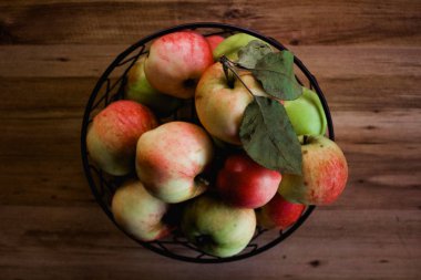 Ripe apples served in bowl on table