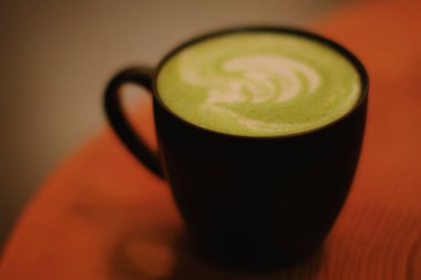 Matcha latte in black mug