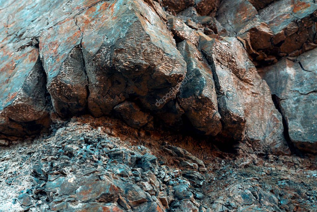 Natural Basalt Rock With Cracks And Crevices With A Red Color Coming From Iron Rock Wall
